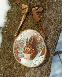 Squirrel in a winter scenery. Acrylic on wood slice 10x11cm